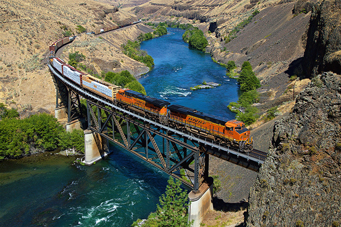 A merchandise train crosses the scenic Deschutes River Canyon at Sherars Falls, Oregon.
