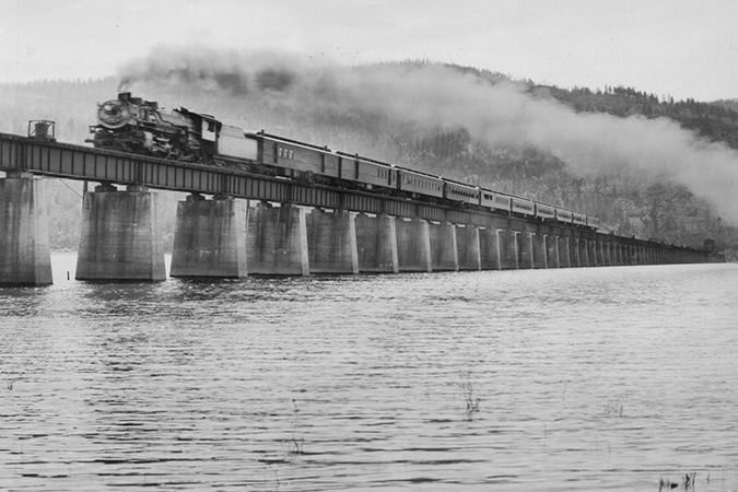 A Northern Pacific locomotive crosses the bridge heading north, with Gold Hill in the background. Courtesy of Bonner County Historical Society.