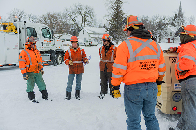 Crew members start their workday with a safety briefing. 